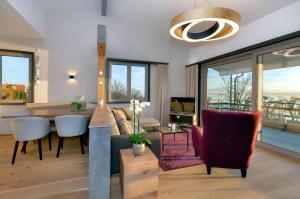 a living room with a couch and a table and chairs at Rosenhof in Stetten