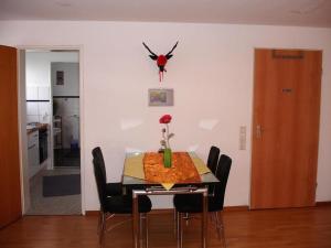 a dining room table with chairs and a spider on the wall at Ferienwohnung Umkirch in Umkirch