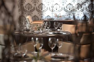 a table with wine glasses on it in a restaurant at Le Temple in NeuhÃ¼tten