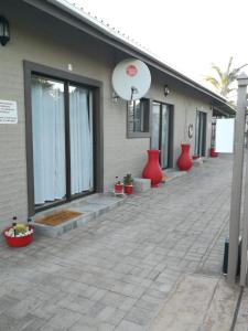 a building with red vases on the side of it at Kalahari Rus in Upington