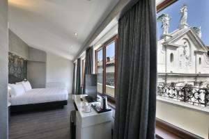 A bed or beds in a room at Al Theatro Palace