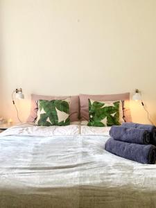 a large bed with two pillows on top of it at Cute Pug Guest Room in Copenhagen +19 photos