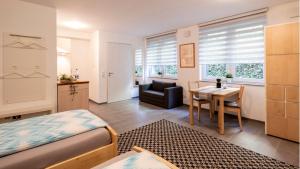 a bedroom with a bed and a table and a chair at Apartment Liß in Gladbeck