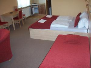 a hotel room with a bed and a table and chairs at Pension Euro in Mikulov