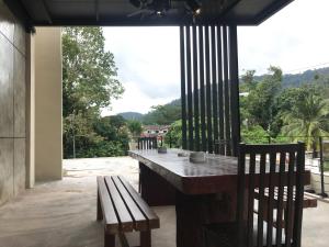 クアンタンにあるLE LODGE MANSIONの大きな窓のあるパティオ(テーブル、椅子付)