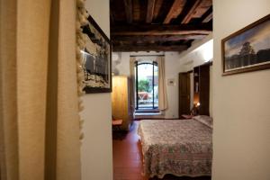 Postel nebo postele na pokoji v ubytování Palazzo Maggiore