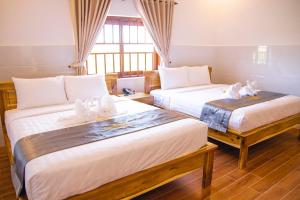 Postel nebo postele na pokoji v ubytování Mui Ne Beach Hotel