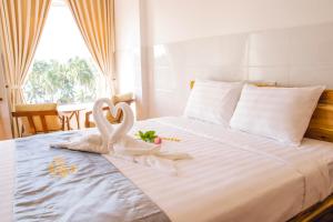 Postel nebo postele na pokoji v ubytování Mui Ne Beach Hotel