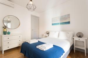 a bedroom with a bed and a mirror at FLH São Bento Charming Flat in Lisbon