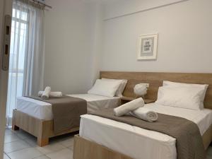 Postel nebo postele na pokoji v ubytování Elounda Canali Apts