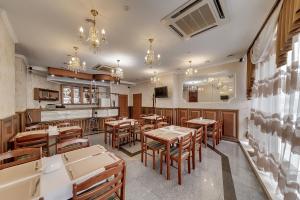 a kitchen with a dining room table and chairs at Soborniy Hotel in Zaporozhye