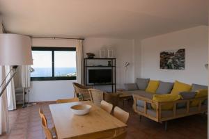 a living room with a couch and a table at 2 bedroom apartment in Begur center. Sea views, terrace and pool (Ref:H09) in Begur