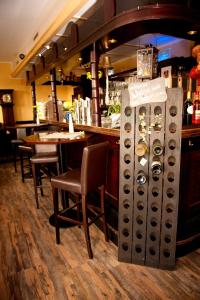 a restaurant with a bar with chairs and a counter at Neubert`s Gasthaus am Rhein in Lahnstein