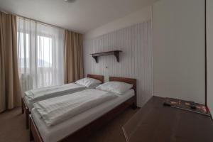 Postel nebo postele na pokoji v ubytování Hotel Polianka