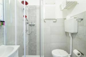 a bathroom with a shower and a toilet and a sink at Hotel Spot Varazze in Varazze