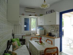 a small kitchen with a table and a table and a tableablish at Alexandros House in Apollonia