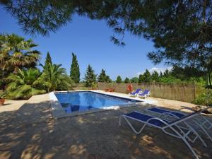 uma piscina com duas espreguiçadeiras ao lado em Belvilla by OYO Ribes em Santa Margalida