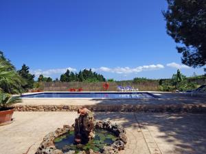 uma estátua de urso de peluche em frente a uma piscina em Belvilla by OYO Ribes em Santa Margalida