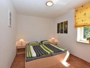 a bedroom with a bed and two night stands at Farm holiday home in Damshagen with garden seating and sauna in Klütz