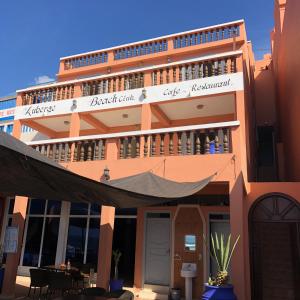 a large building with a balcony with people on it at HOTEL BEACH CLUB LEGZIRA in Sidi Ifni