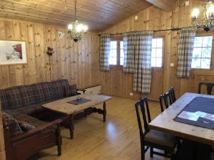 a living room with a couch and a table at Haglebu Turistheim in Haglebu