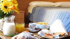 a breakfast tray with milk bread and eggs and a bed at Central Plaza in Lecce