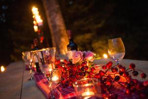 a table with wine glasses and flowers and candles at Bayern Resort Hotel - Adults only - mit Zugspitzblick - Eibsee-Nähe - Wellnessbereich - Naturpool im Sommer in Grainau