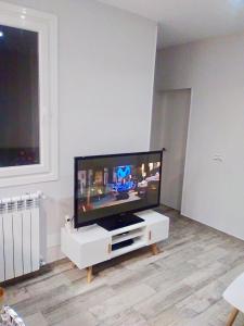 a living room with a large flat screen tv at Apartamento estilo nórdico en Malasaña (Madrid Centro) in Madrid