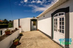 un edificio bianco con una porta e un vialetto di Quinta de Sao Carlos ad Angra do Heroísmo