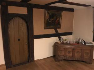 a room with a wooden door and a dresser at McMüller's Kemenate Fulda in Fulda