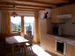 a kitchen with a table and a table and a dining room at Haus Edelweiß in Bad Hindelang