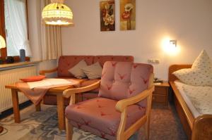 a living room with a couch and a table and a chair at Haus Zillach in Bad Hindelang