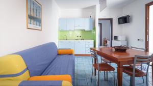 a living room with a blue couch and a table at Vivaldi Appartamenti in Marinella di Selinunte