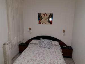 a bedroom with a bed and a picture on the wall at Hostal Angelines in Madrid