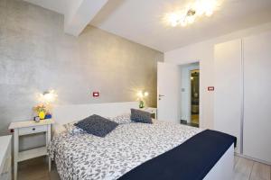 a bedroom with a bed and two night stands at Villa Olea in Koromačno +19 photos
