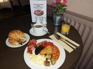 a table topped with plates of food and drinks at Corn Mill Lodge Hotel in Leeds