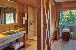a bathroom with a shower and a sink and a tub at Boutique hotel Vila Planinka in Zgornje Jezersko