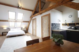 a living room with a wooden floor and a large window at Antwerp B&B in Antwerp