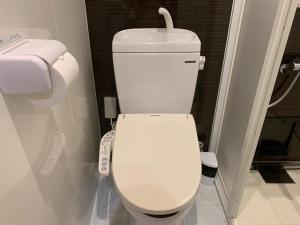 a bathroom with a white toilet in a room at Seaside Hotel The Beach in Chatan +34 photos