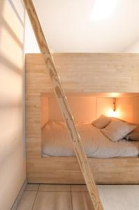 a bedroom with a bed in a wooden frame at Studio zwembad met frontaal zeezicht in Ostend
