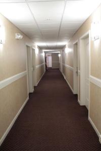 a hallway of an office building with a long corridor at Shiretown Inn & Suites in Houlton +11 photos