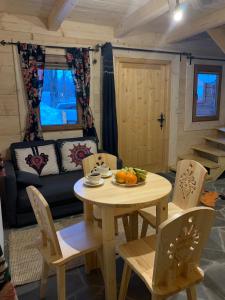 a table and chairs in a living room with a couch at Dadejówka Zakopane in Zakopane