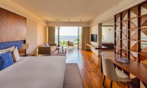 a hotel room with a bed and a view of the ocean at Le Grand Galle in Galle