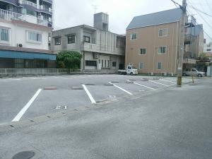 an empty parking lot in a city with buildings at Seaside Hotel The Beach in Chatan