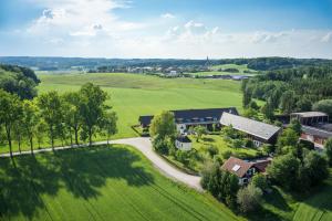 an aerial view of a house in a green field at Hofgut Algertshausen in Eresing