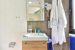 a bathroom with a white sink and a mirror at Hotel Apartamento Bajamar in Las Palmas de Gran Canaria