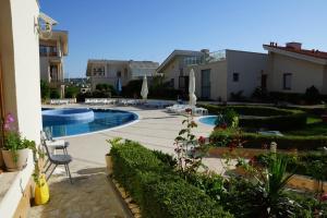 a courtyard with a swimming pool and some buildings at Sun Village Family Houses in Byala