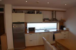 a small kitchen with a sink and a refrigerator at Sun Village Family Houses in Byala