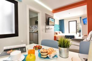 a room with a table with food on it at Hotel Apartamento Bajamar in Las Palmas de Gran Canaria