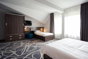 Posteľ alebo postele v izbe v ubytovaní Hotel Nad Nettą